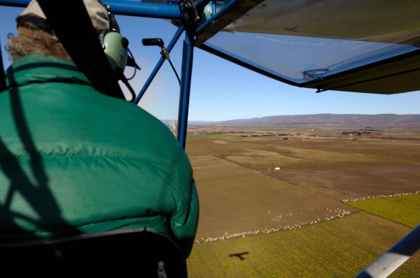 At the controls of his RANS S7 Courier, Dave Witherow contemplates the shadow of his microlight moving over the austere landforms of Central Otago near Ranfurly. 