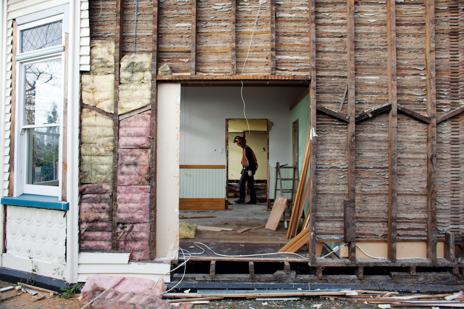 A demolition crew from Silvan Salvage remove recyclable items from a home before the diggers move in. Metals are prized, timber is recycled or chipped for fuel, bricks and concrete are crushed and used for landscaping, roading or basement fill and even gib board can be recycled.