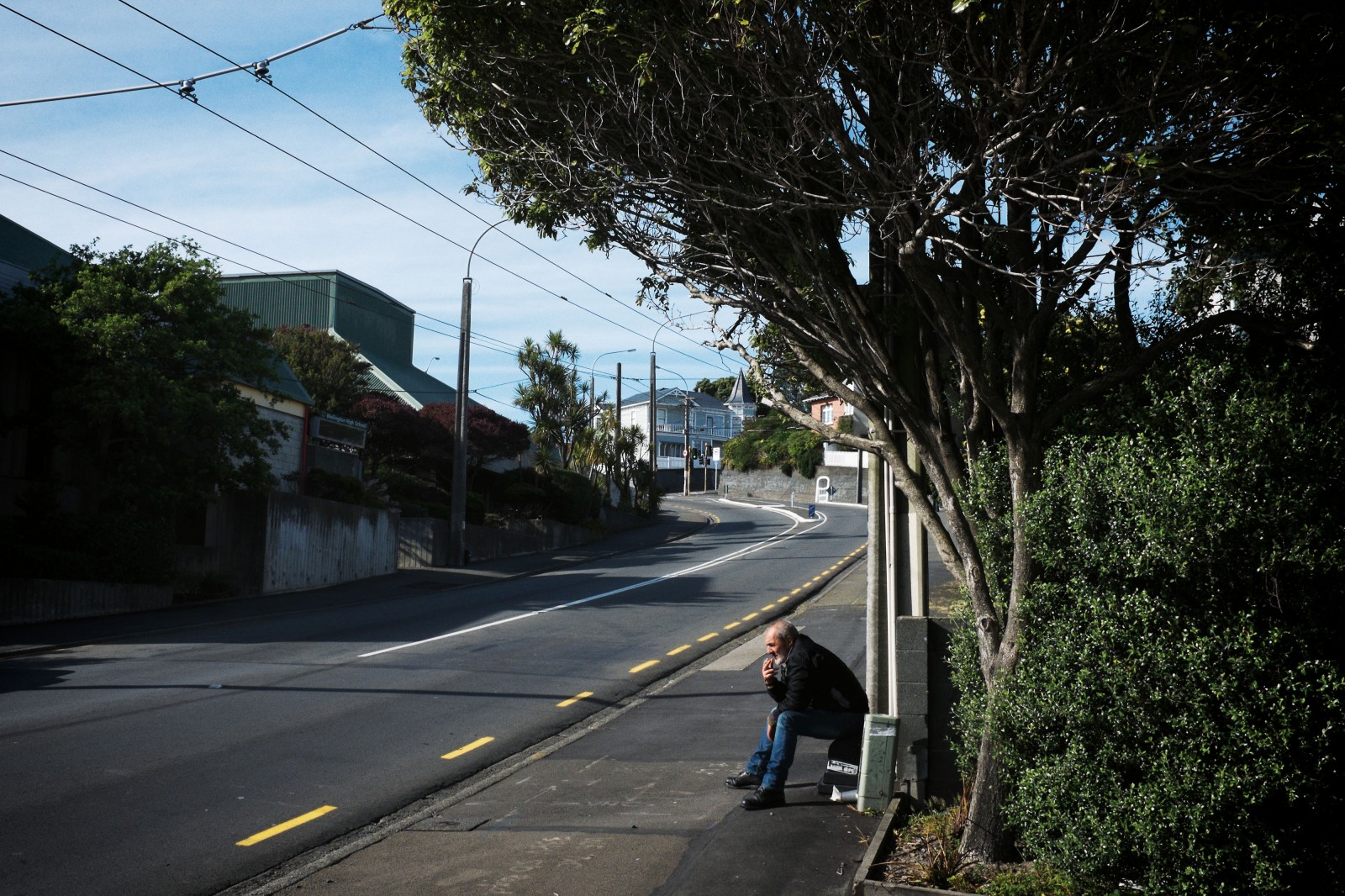 ‘Ari’, a man who has experienced homelessness for over a decade, sits on a bench outside the Wellington night shelter on upper Taranaki Street. The night shelter provides beds for 45 men, many of whom, like ‘Ari’, are cycling through different types of sub-standard housing. Wellington Council has recently provided funding for a social worker to help guests engage with health and other services, but the shelter lacks the funding to assist everyone who comes through its doors.