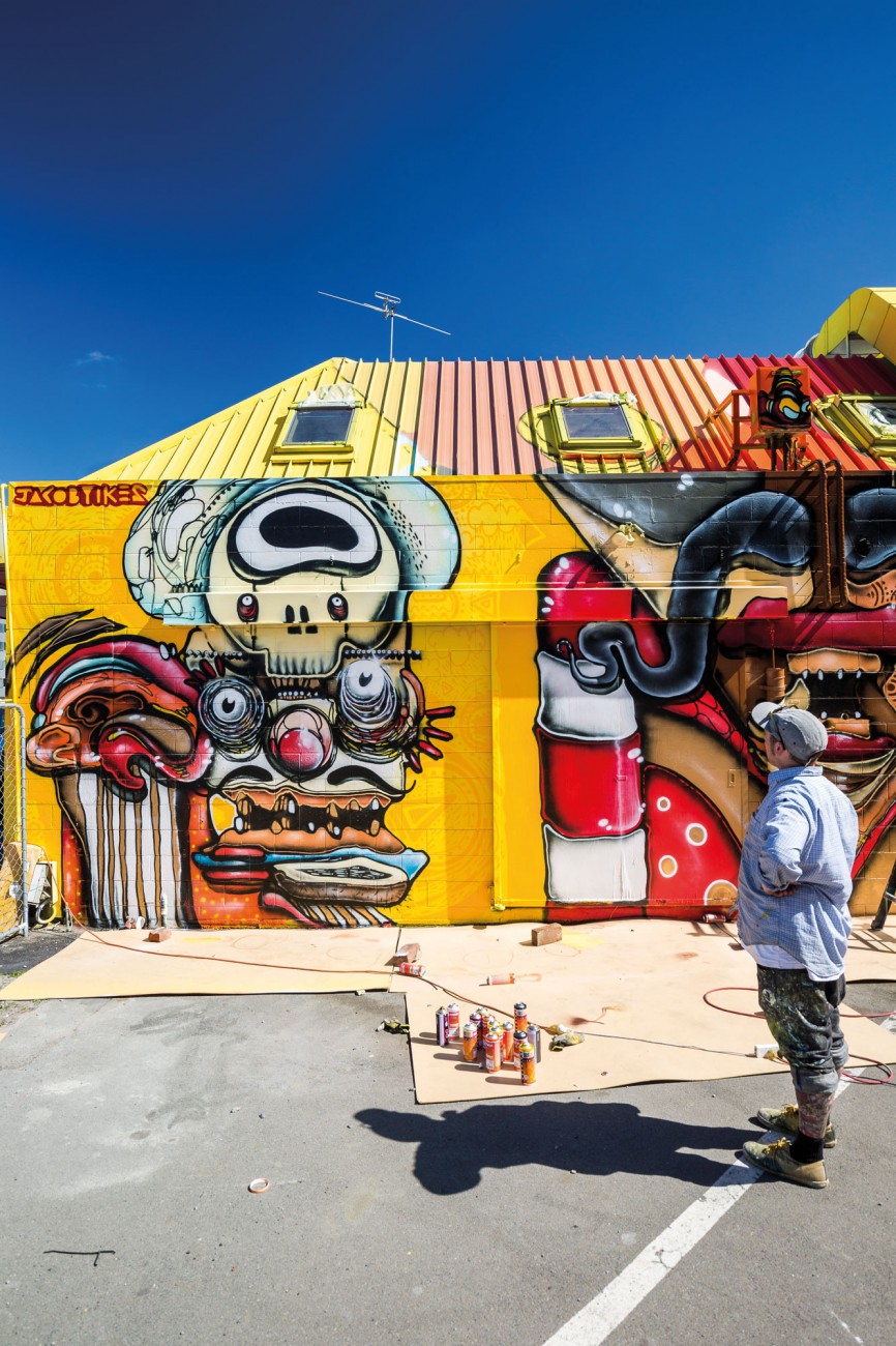 132_streetwise_bodyimage4 Artist Jacob ‘Yikes’ Ryan surveys his trio of “mad Mexicans”, a commissioned work for the 65-square-metre wall and roof of a new Mexican restaurant in downtown Christchurch.