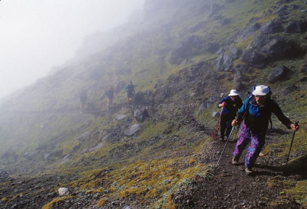 Guide Ian McAlpine (above, front) has made 1450 trips up Mt Taranaki since 1961. “The mountain is just the right height for a one-day climb,” he says. “If the summit was 300 m lower, then to a lot of people it might not be a challenge; 300 m higher and we would have to do the trip over two days.”