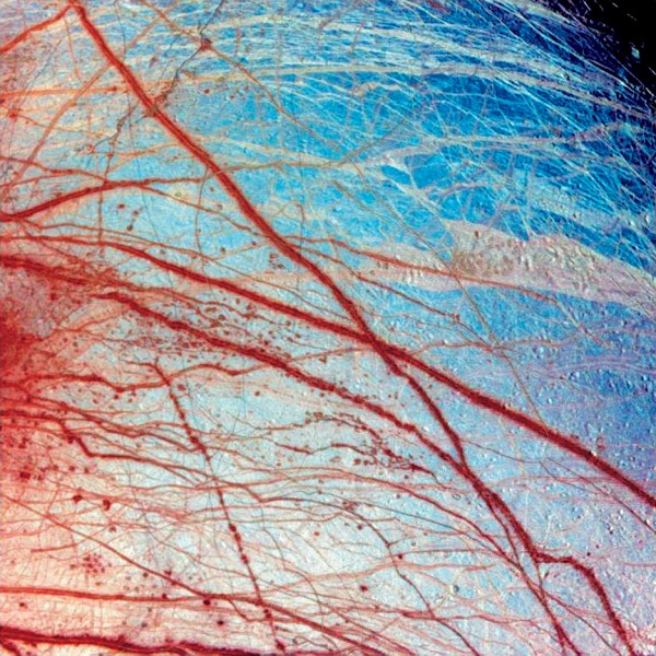 Europa's icy crust displays network of fractures over the entire surface, clearly seen in this false colour image. Beneath the mantle, a shell of water could extend down 50-100 km, warmed by tidally generated heat. Europa appears to have all three primary ingredients for life: water, heat and organic compounds.