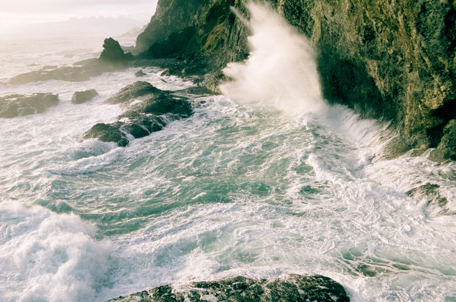 Wild water hammers the cliffs at Cape Reinga.