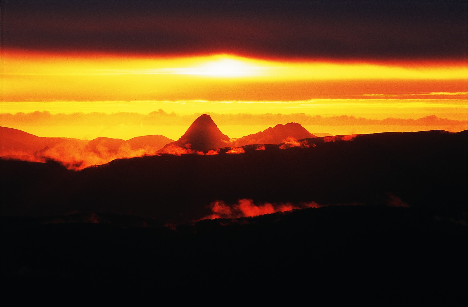 The granity heads of Gog (at left) and Magog are silhouetted by a classic Rakiura sunset in this view to the south-west from the Tin Range. The Maori name for tis island literally means "glowing skies." Golden vistas couldn't compensate for empty pockets, however, and the great tin rush of 1889 turned out to be a little more than a flash in the pan.