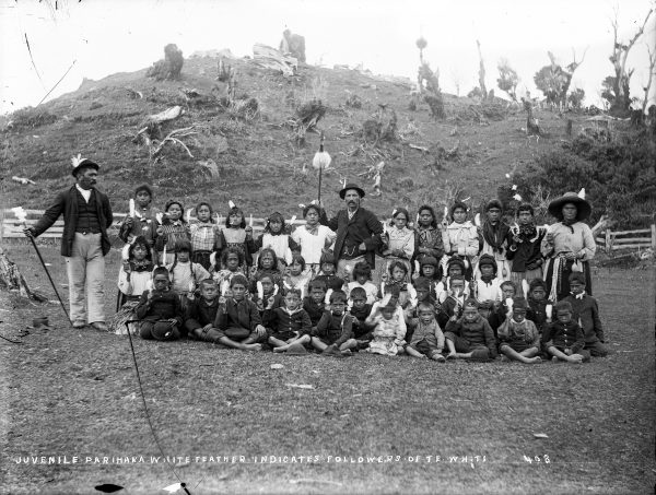 Affectionately known as tātarakihi, the singing cicadas, children played a lead role in the Parihaka’s response to invasion. They played skipping games at the entrance to the pā and sang waiata as the soldiers approached. The children in this group portrait hold the raukura, the white albatross feather, a symbol of peace and the timeless emblem of Parihaka, New Zealand’s birthplace of nonviolent resistance.