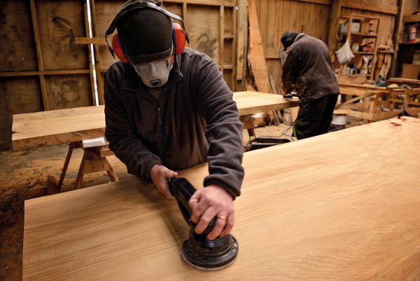 142_Swamp-Kauri_07 Like these slabs being sanded at Nelson Parker’s workshop, the majority of the swamp kauri exported as finished products takes the form of tabletops. Environmental groups claim the rules leave the door open for people to send out what is essentially raw timber, with importers then able to add value overseas. “As long as it’s passed by MPI, I don’t care,” says Parker. “I’m here to do business and I’m not going to stop because somebody might decide to reprocess this.”